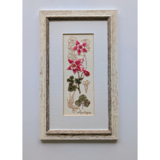 Stitched and framed embroidery artwork featuring elegant pink flowers with detailed leaves on a light fabric background.