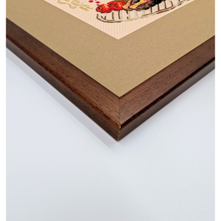 Stitched and framed embroidery artwork depicting a plated dinner with grilled meat and fresh vegetables arranged playfully.