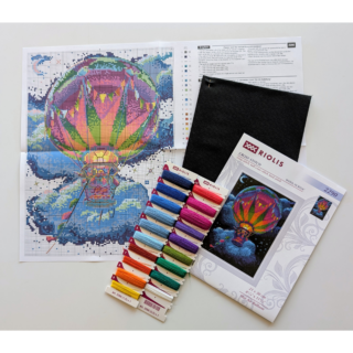Cross-stitch of a colorful hot air balloon glowing against a night sky with stars, clouds, a crescent moon, and bright streamers.