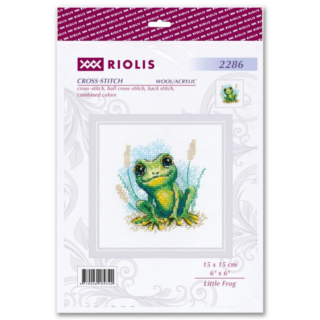 Cross-stitch design of a small green frog with bright yellow accents sitting in grass with a watercolor-style background.