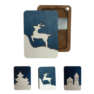 Handcrafted wooden needle case with winter-themed cutout on blue background.