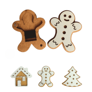 Festive wooden needle cases shaped like a gingerbread man, cookie house, and Christmas tree, with white icing details and magnetic interiors.