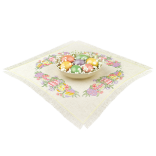Embroidered table topper with colorful Easter eggs, spring flowers, and a central bowl filled with pastel eggs and baby’s breath.