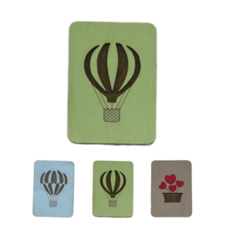 Wooden needle case with a minimalistic cutout on a pastel background.