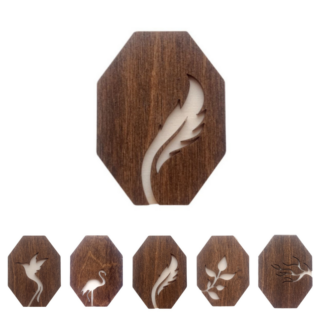 Wooden needle cases with natural cutout designs including a feather, hummingbird, flamingo, tree branch, and leaves, made from dark-stained wood.