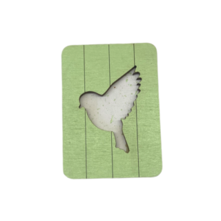 Light green wooden needle case with a bird-shaped cutout and paneled background.