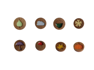 Set of eight Kind Fox wooden magnetic needle minders featuring autumn designs including leaf, cloud, acorn, clover, umbrella, mushroom, maple leaf, and pumpkin on round wooden bases.